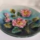 Decorative plate with relief floral pattern in majolica.