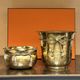 Pair of brass plant pots, decorated with cord and tassels.