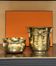 Pair of brass plant pots, decorated with cord and tassels.