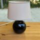 Vintage 80s table lamp with a black ceramic base and beige shade.