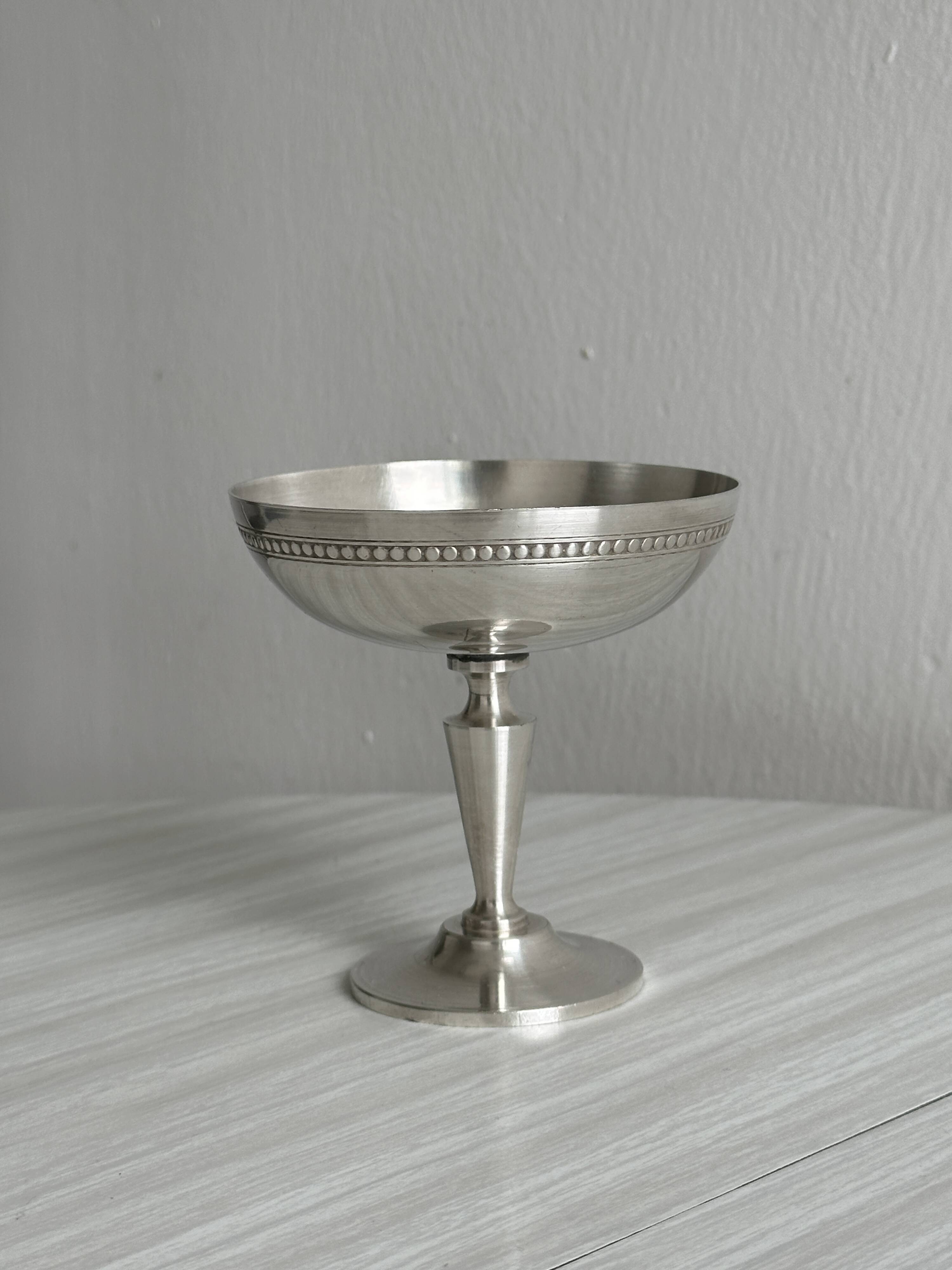 Silver-plated metal bowl on a stand