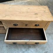 An old piece of workshop furniture transformed into a TV stand