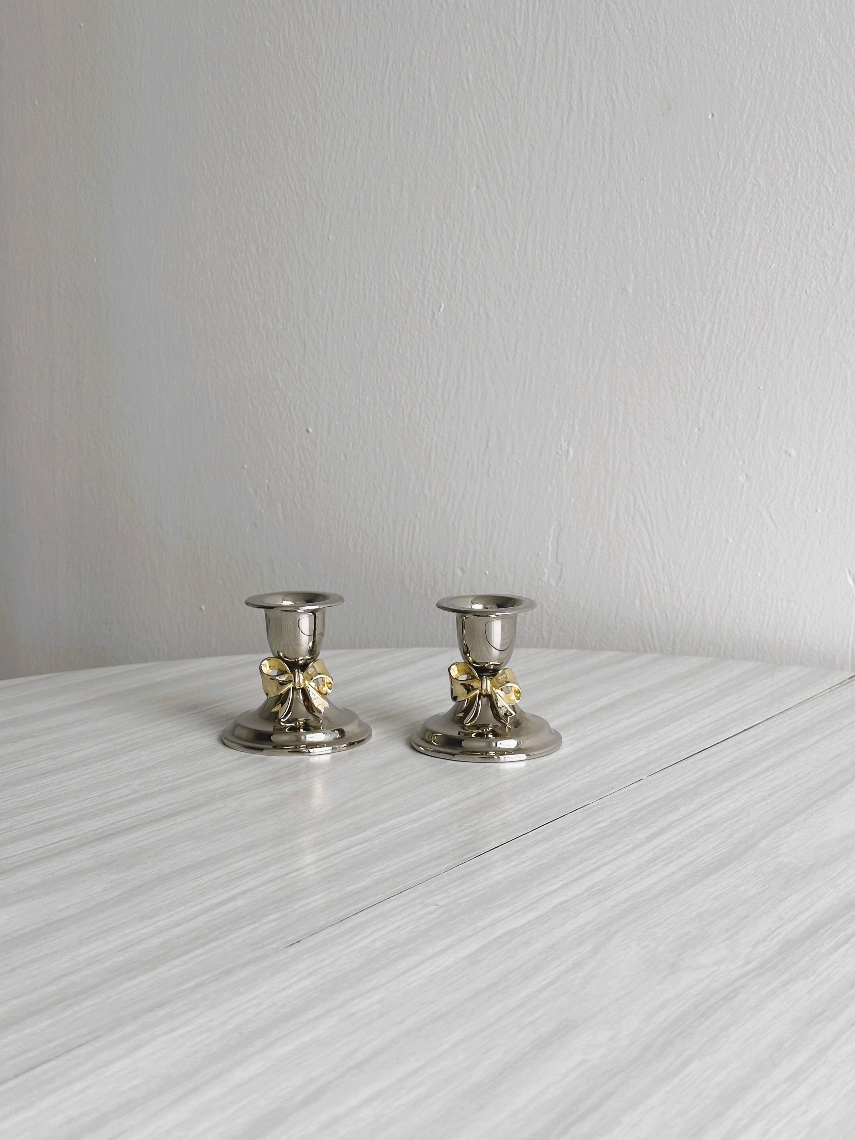 Pair of small antique metal candlesticks
