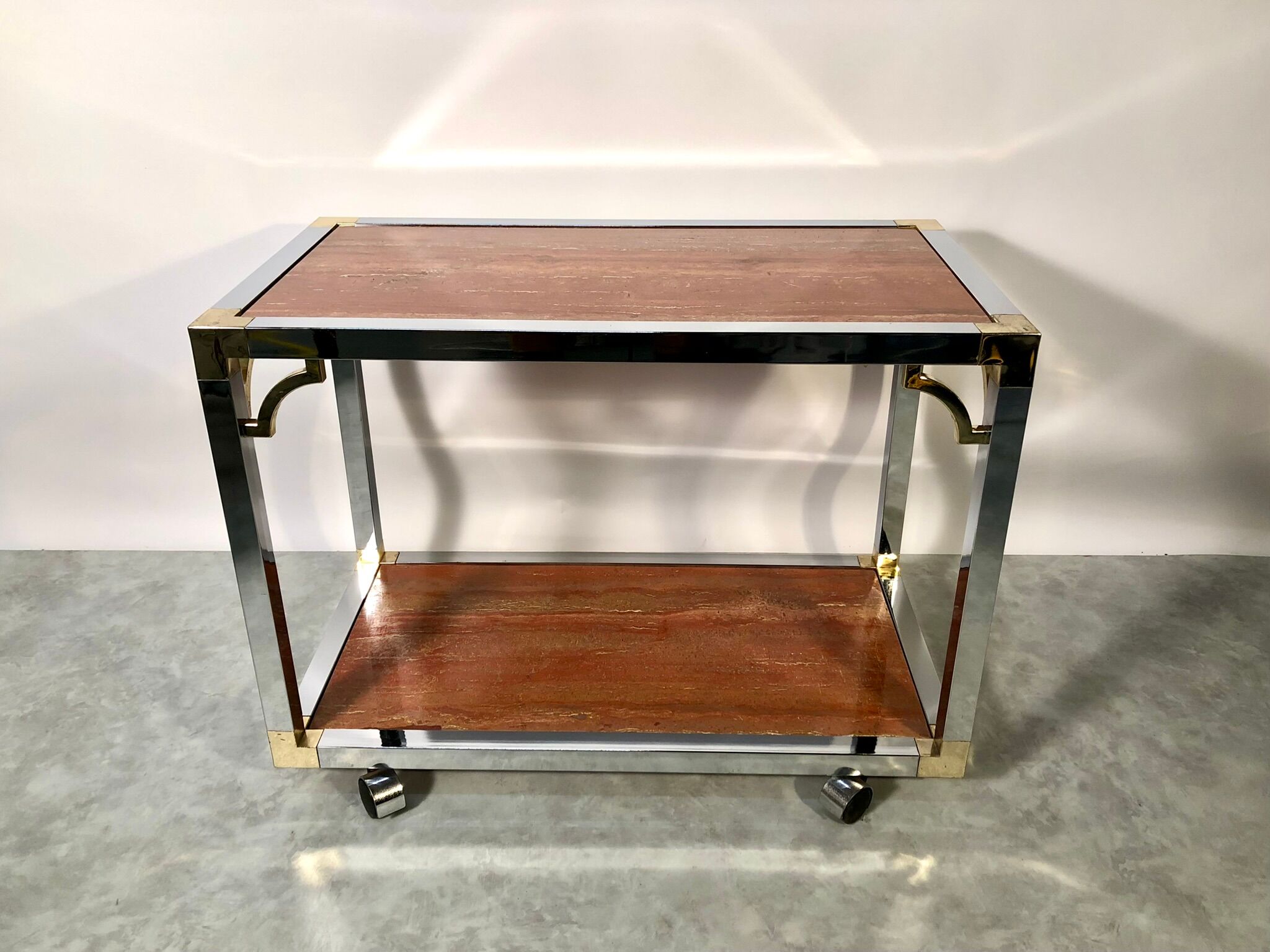 Italian rolling dessert table with two trays decorated with pink travertine
