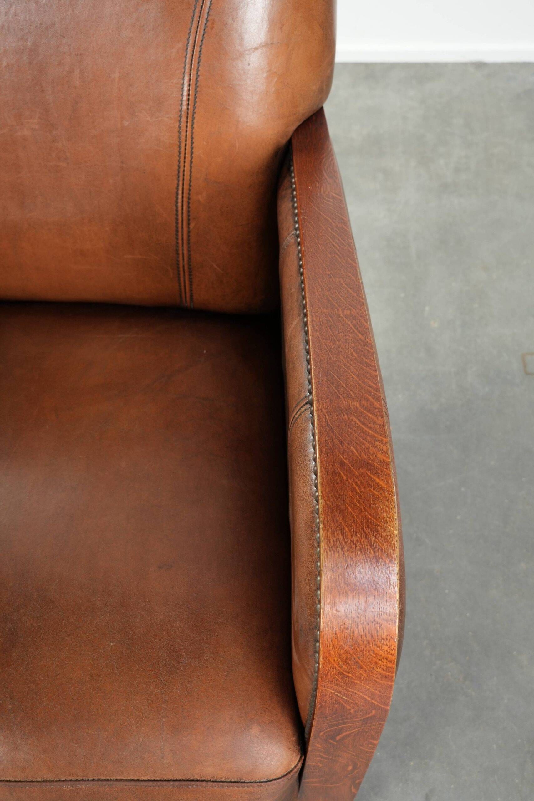 Sheepskin armchair in Art Deco style with wooden armrests