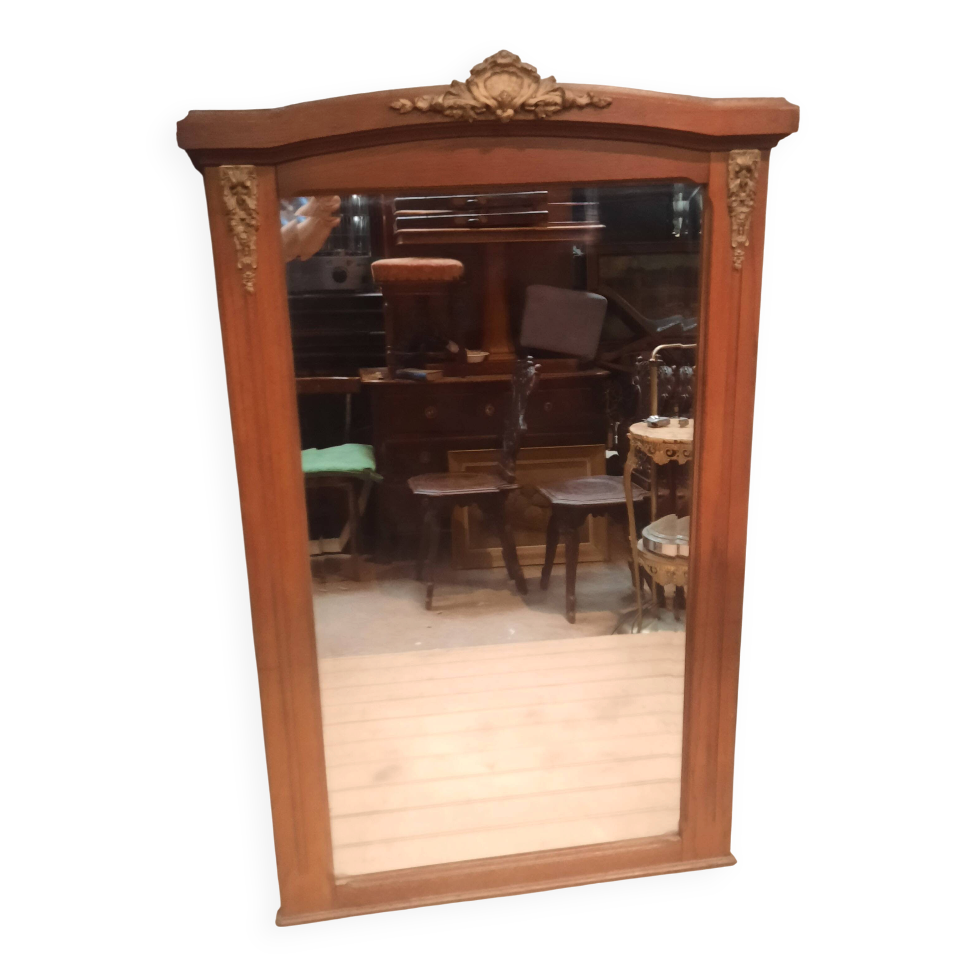 Bevelled mirror surrounded by a wooden frame.