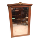 Bevelled mirror surrounded by a wooden frame.