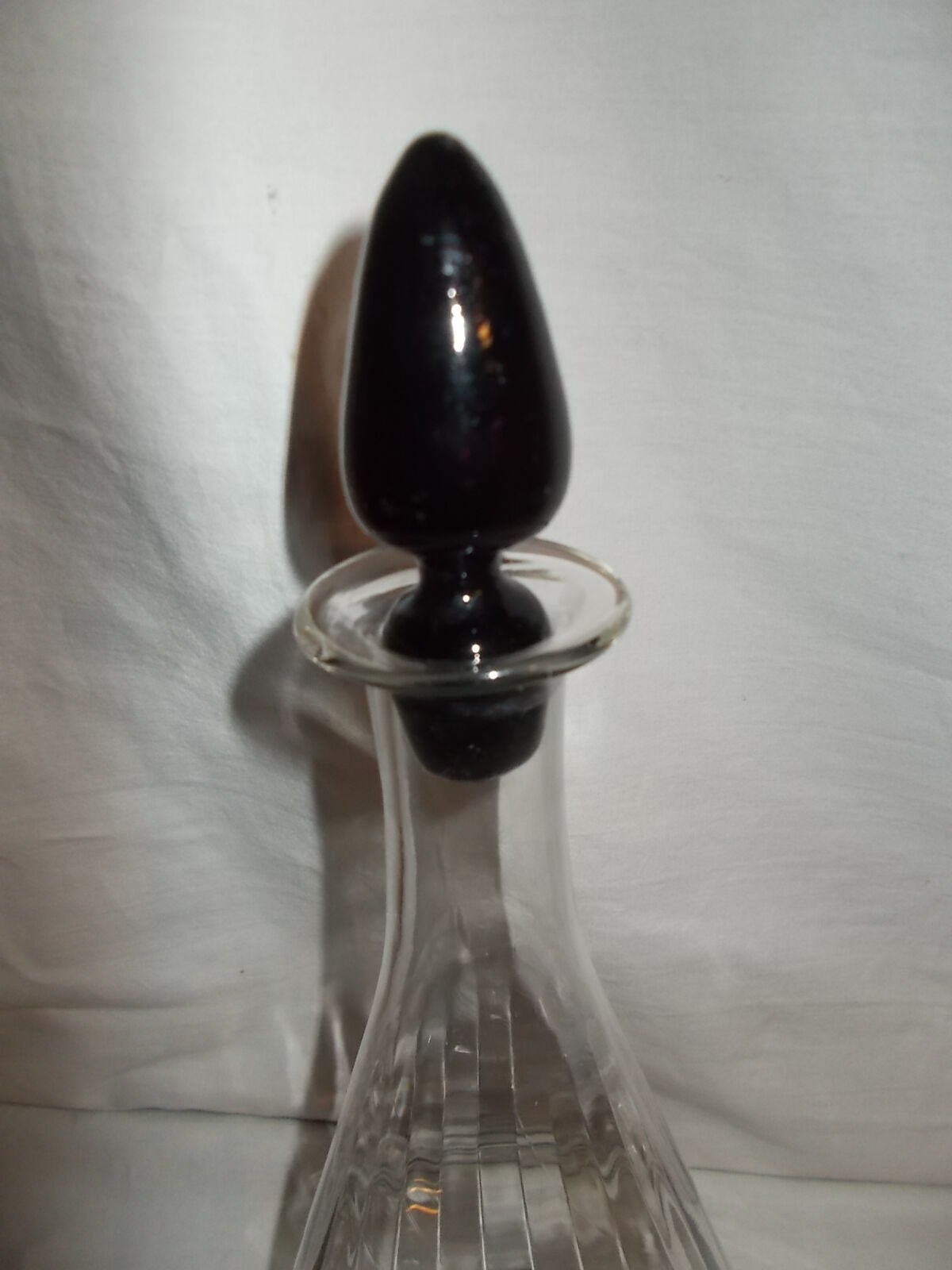 Dark purple glass wine carafe with a stopper.