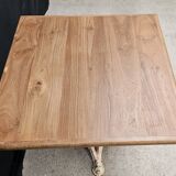 Bistro table with cast iron base and solid teak top