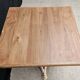 Bistro table with cast iron base and solid teak top