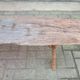 French country style cast iron bench with old rustic wooden plank