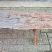 French country style cast iron bench with old rustic wooden plank