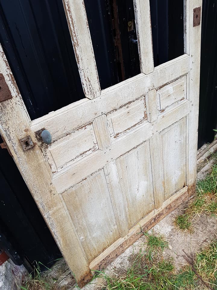 Ancient paneled solid oak door with 3 windows