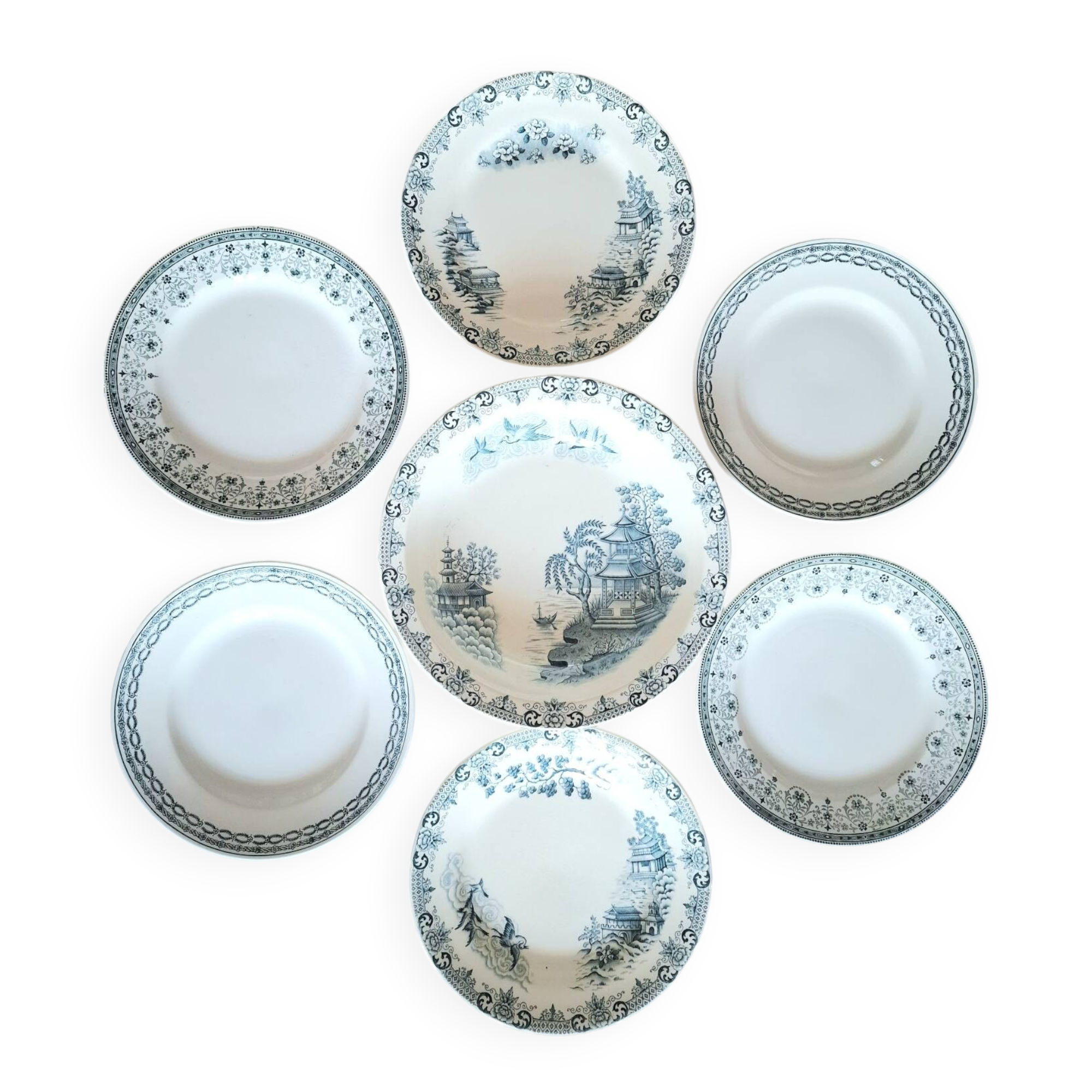 Mismatched antique flat plates made of ironstone accompanied by