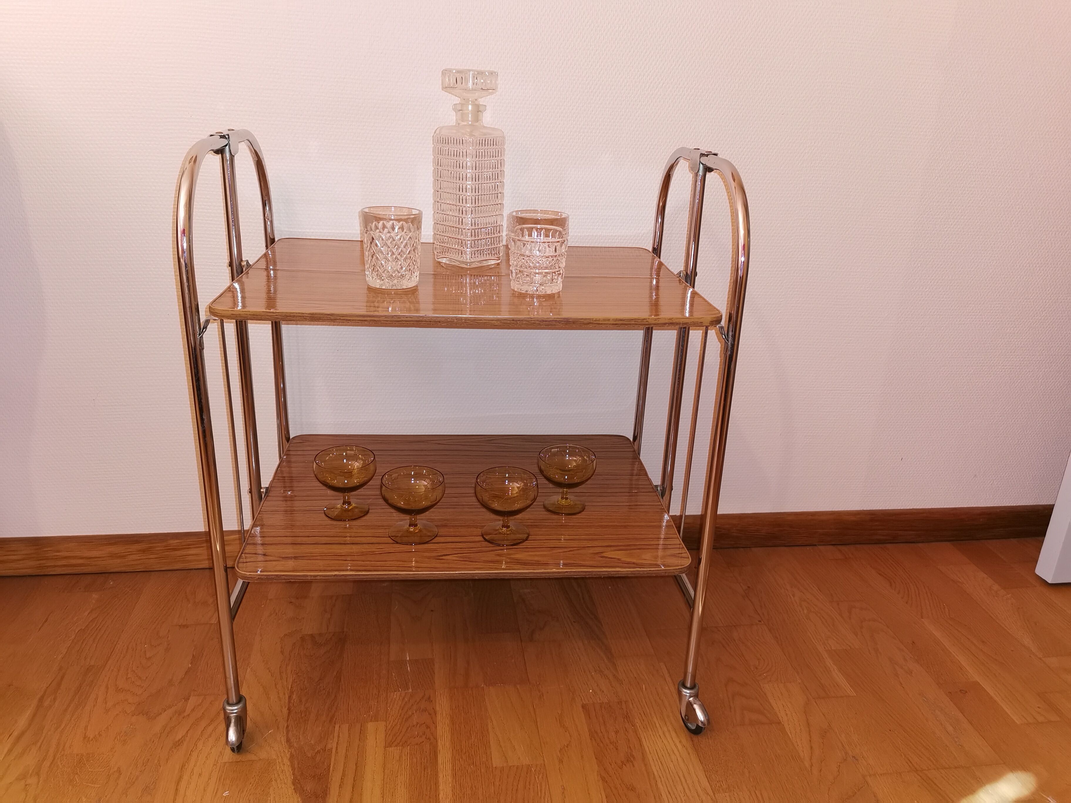 Vintage rolling and folding dessert trolley in chrome metal.