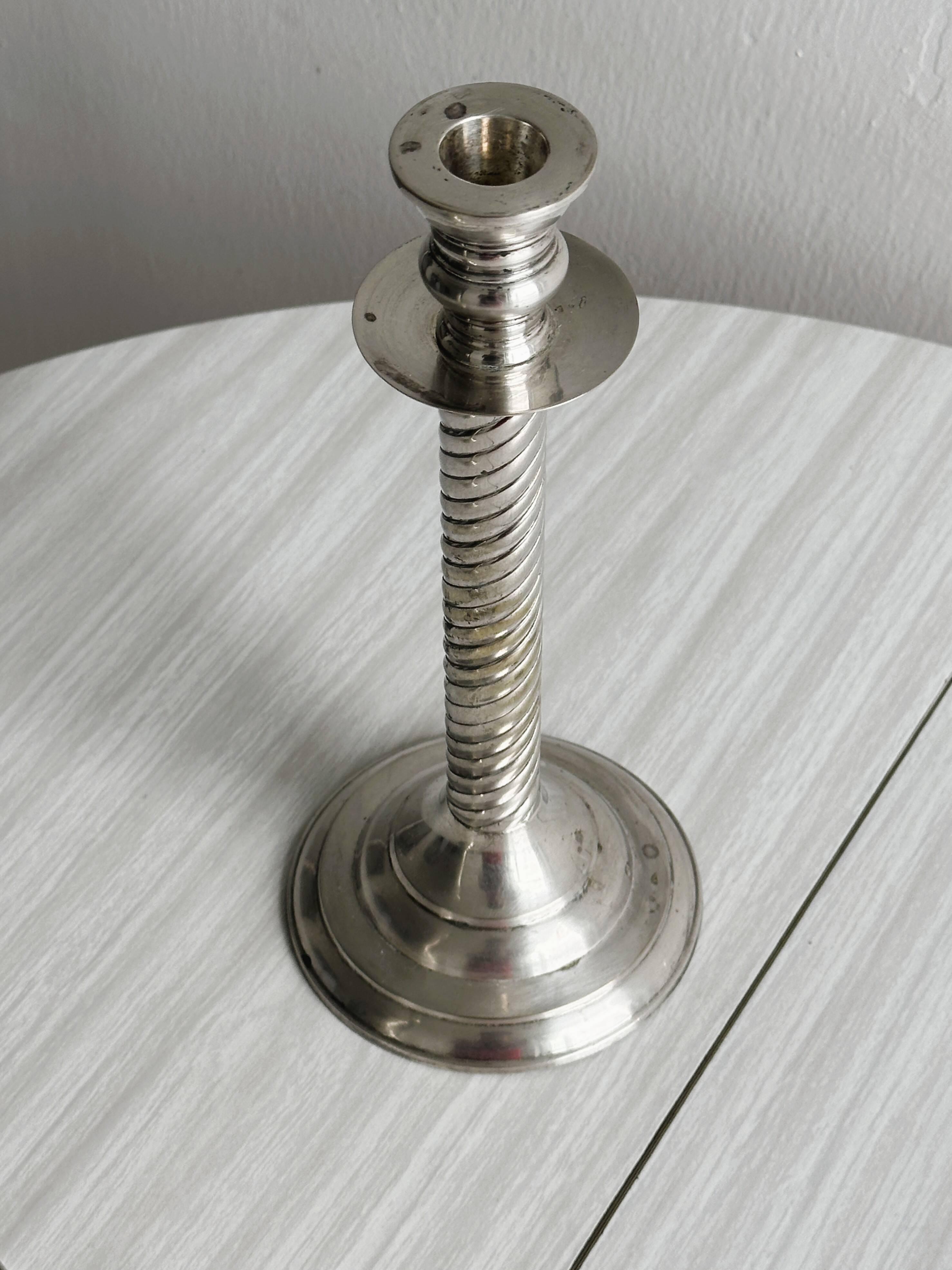 Patinated silver-plated metal candlesticks