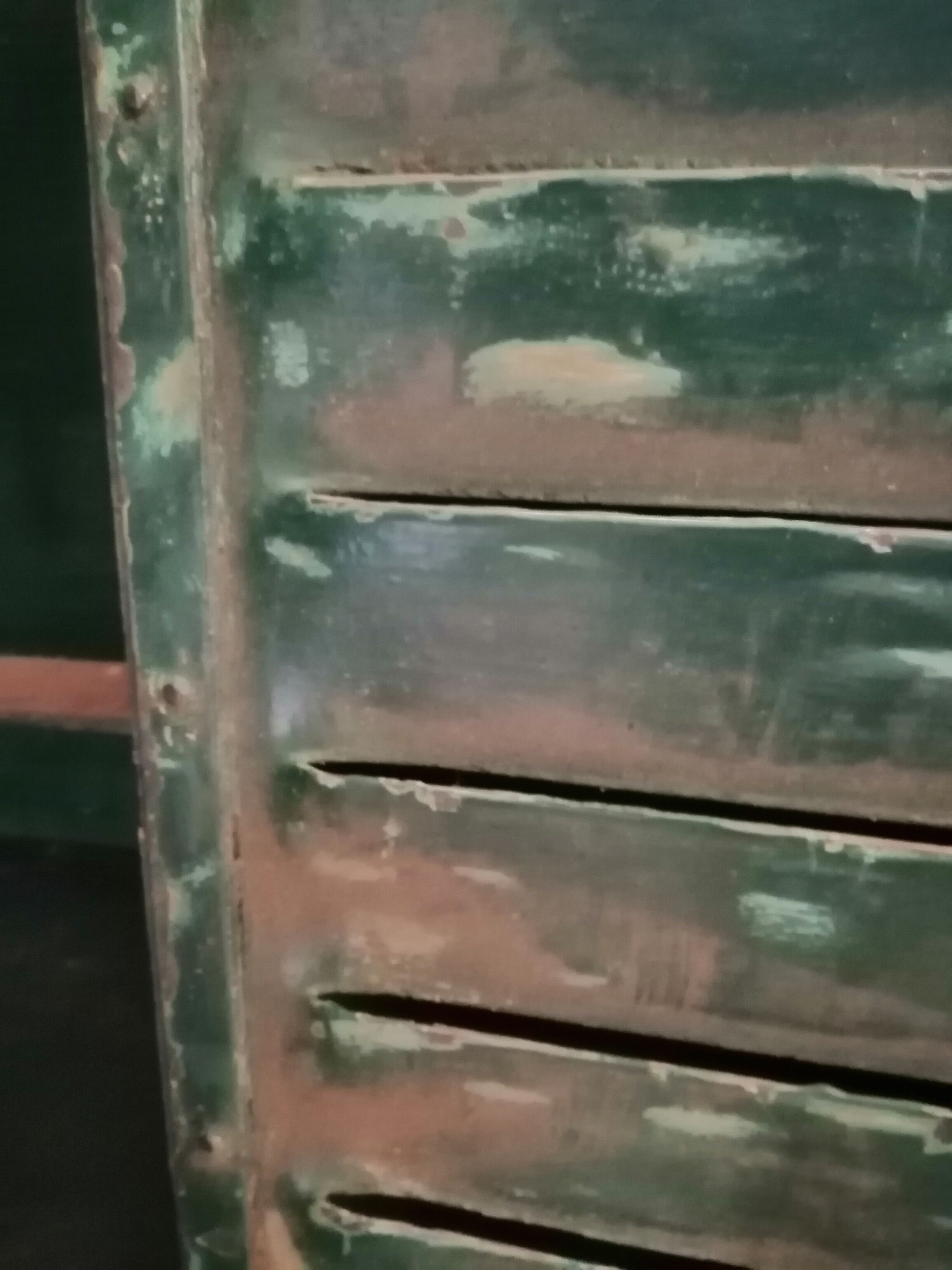 Lot of old green shutters in 4-part iron screen headboard