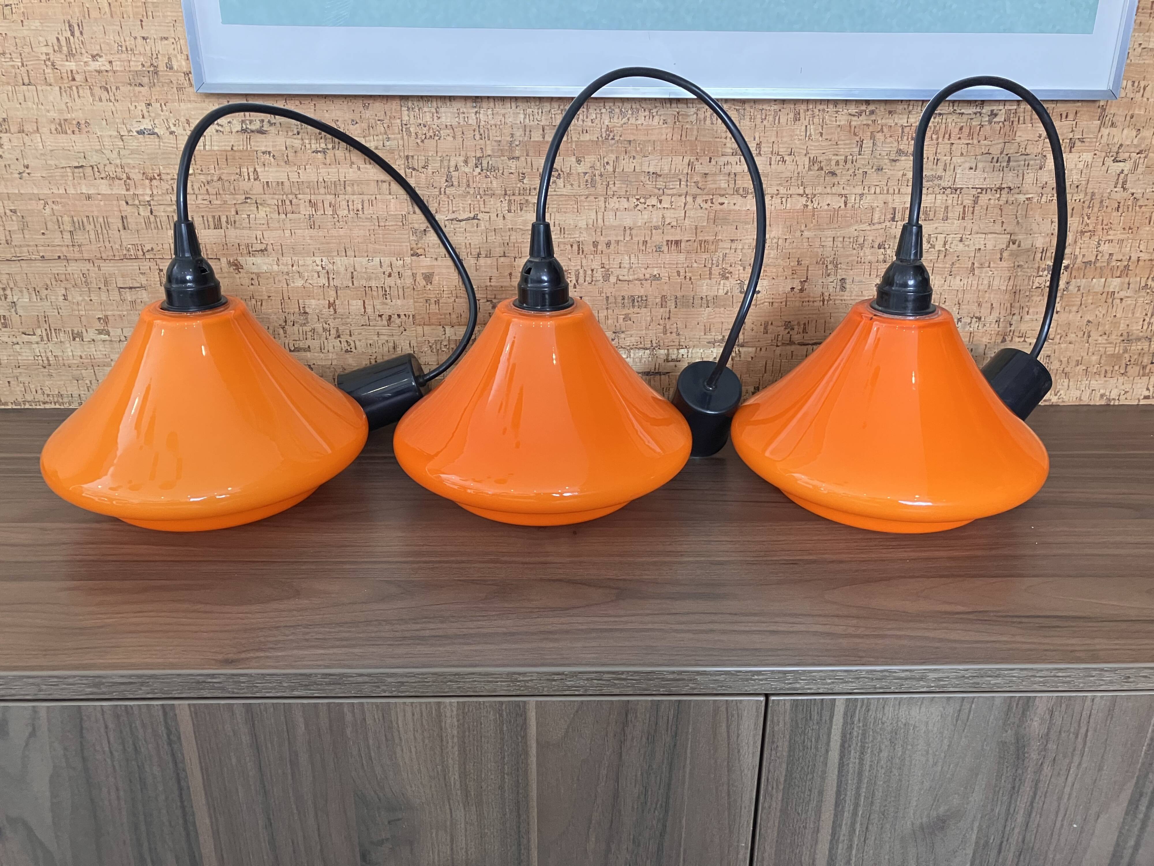Set of three orange opaline suspensions from the 1970s Space Age.