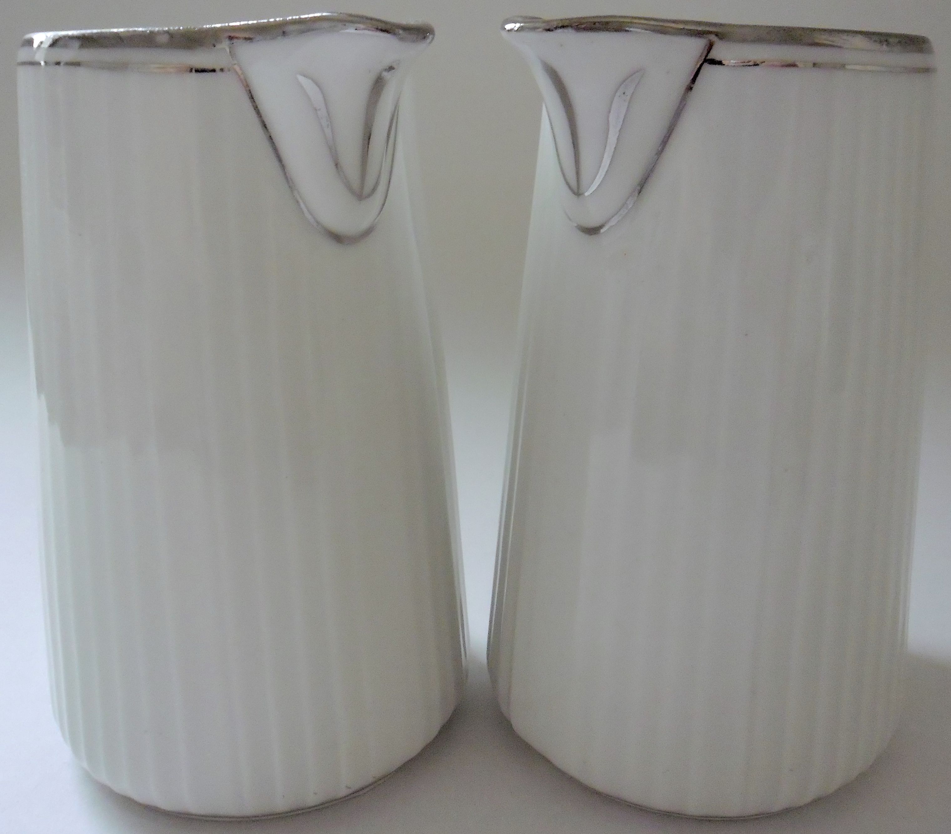 Pair of creamers in white porcelain enhanced with platinum