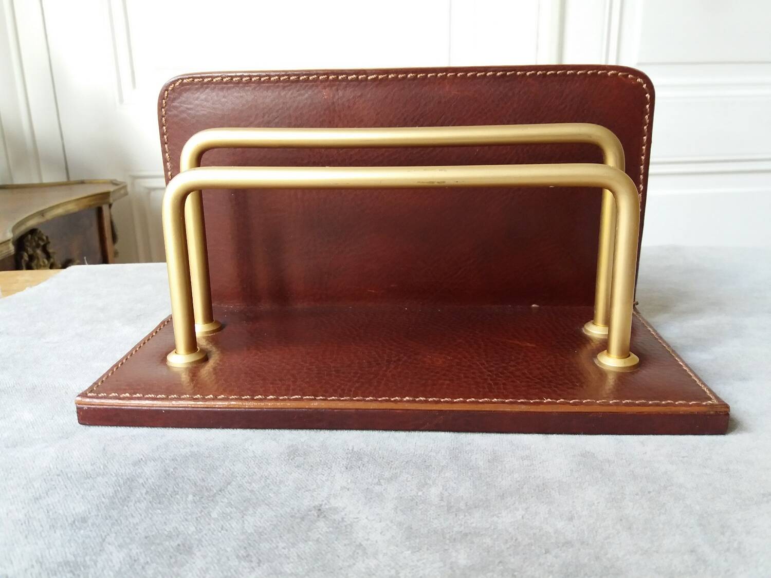 Letter holder covered in leather and golden metal by roche design
