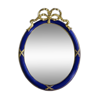 Miroir ovale en bleu et or avec crête de ruban noué