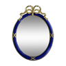 Oval mirror in blue and gold with knotted ribbon crest