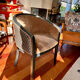 Pair of Art Deco barrel chairs in black and bronze
