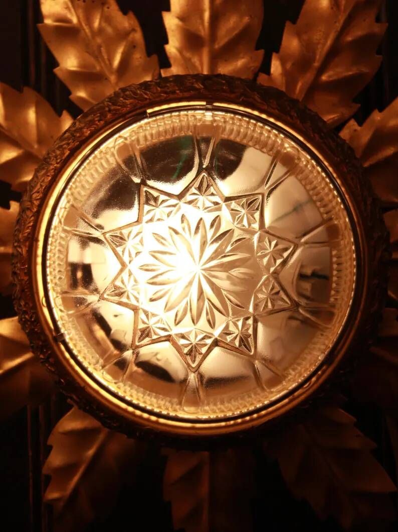 Gold metal wall sconce with cut glass in Hollywood Regency style from the 1960s.