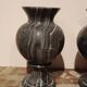 Pair of black serpentine marble vase-urns, early 20th century, Empire style