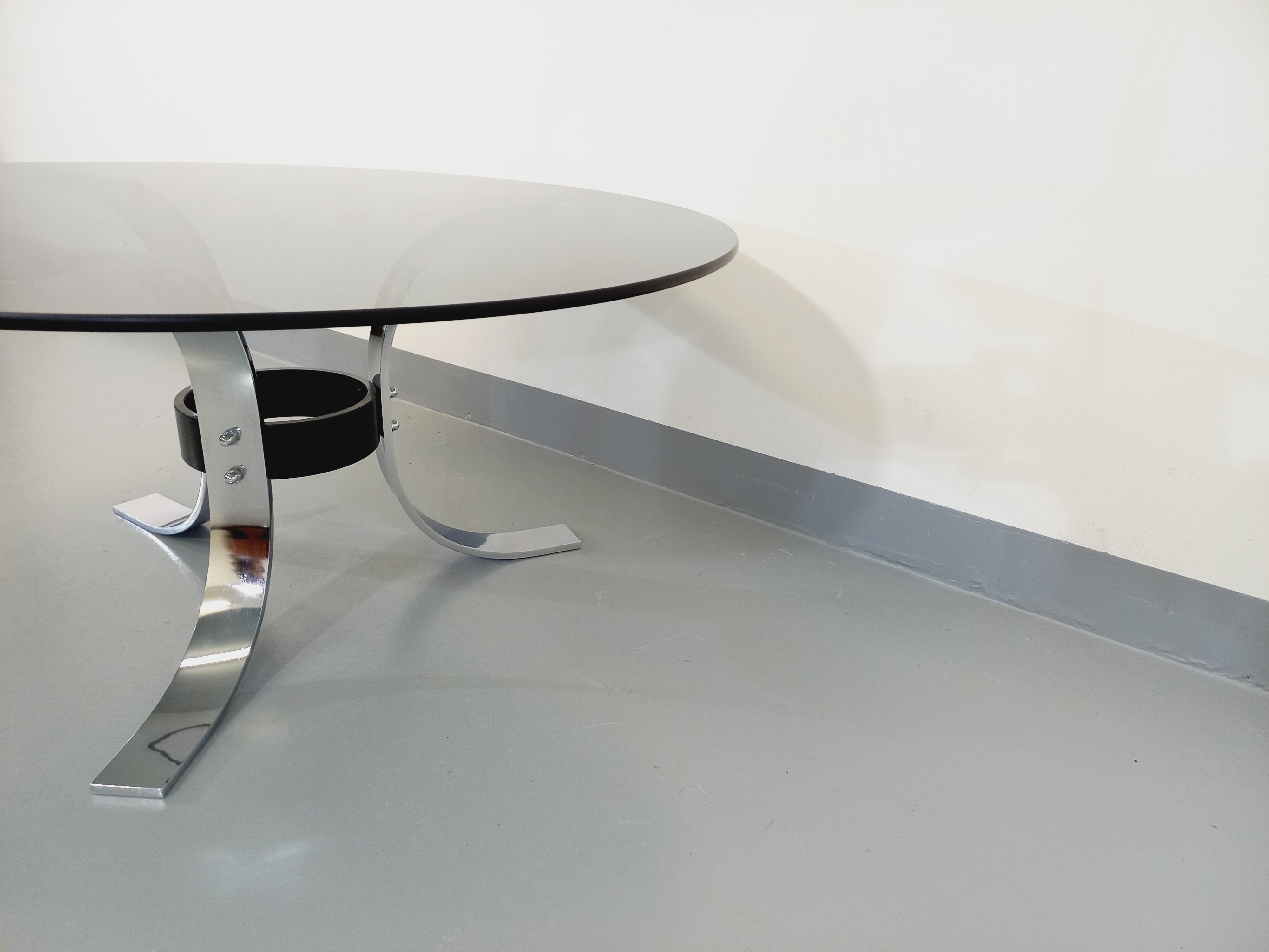 Vintage round coffee table in glass, chromed metal and black metal Space Age style of the 70s