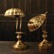 Pair of articulated brass lamps in the shape of a shell.