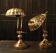 Pair of articulated brass lamps in the shape of a shell.
