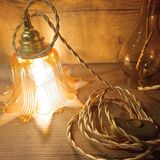 Amber tulip glass portable lamp, golden braided cord.