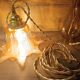 Amber tulip glass portable lamp, golden braided cord.