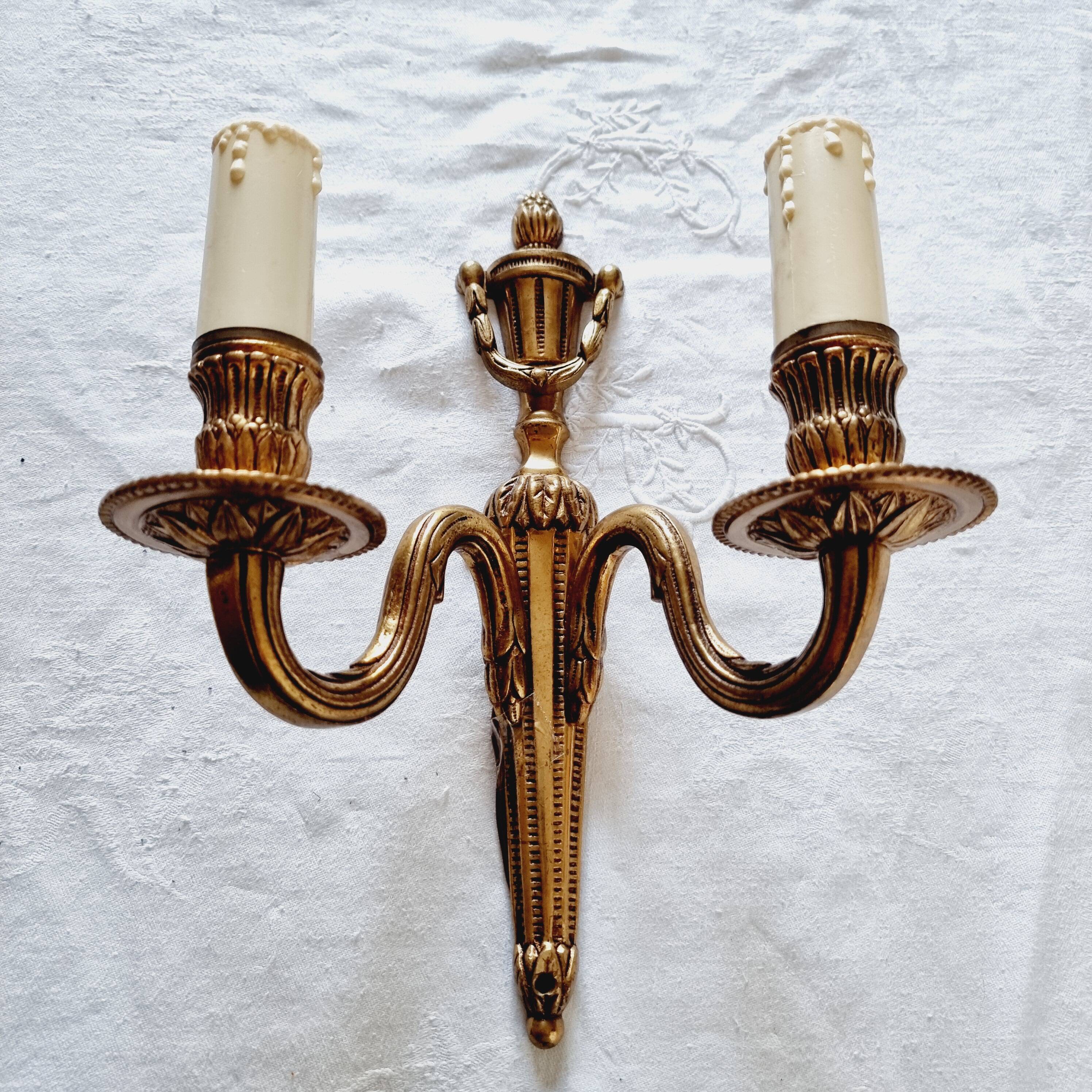 French Empire-style wall sconce or chandelier in bronze with an antique gold patina.