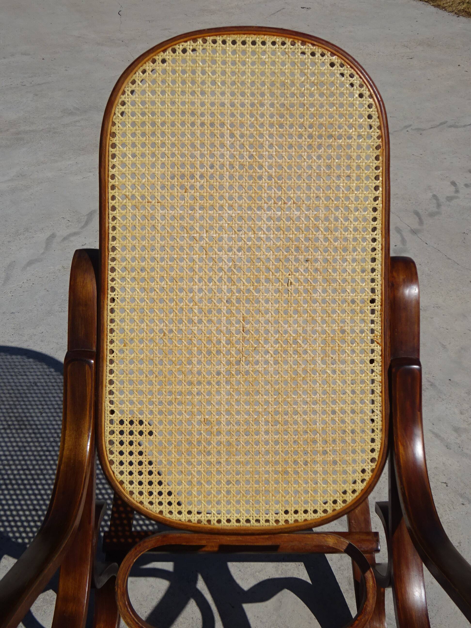 Vintage wooden rocking chair with caning