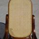 Vintage wooden rocking chair with caning