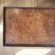 Occasional table in walnut burl and brass gallery.