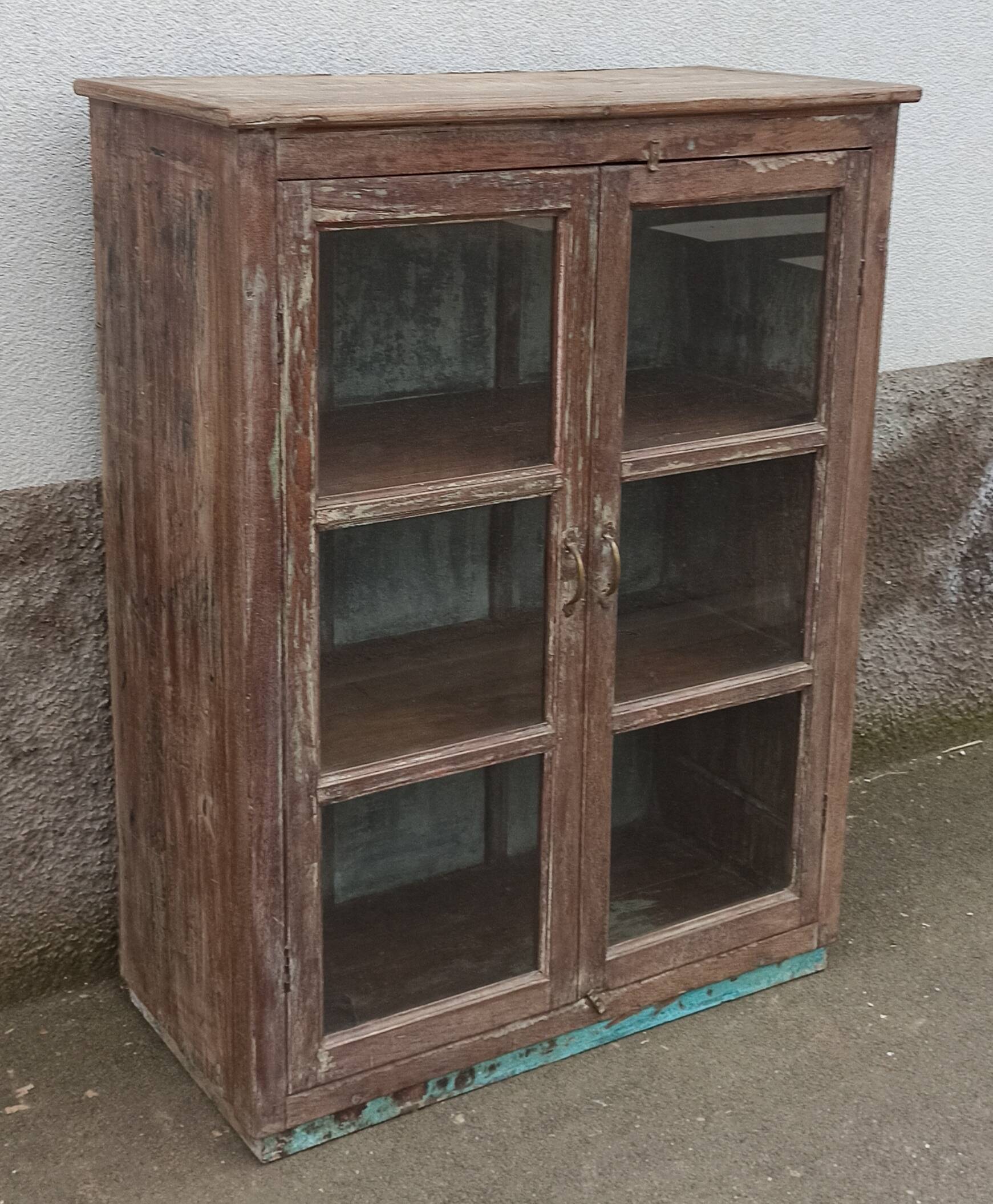 Old glazed wooden cabinet with metal bottom