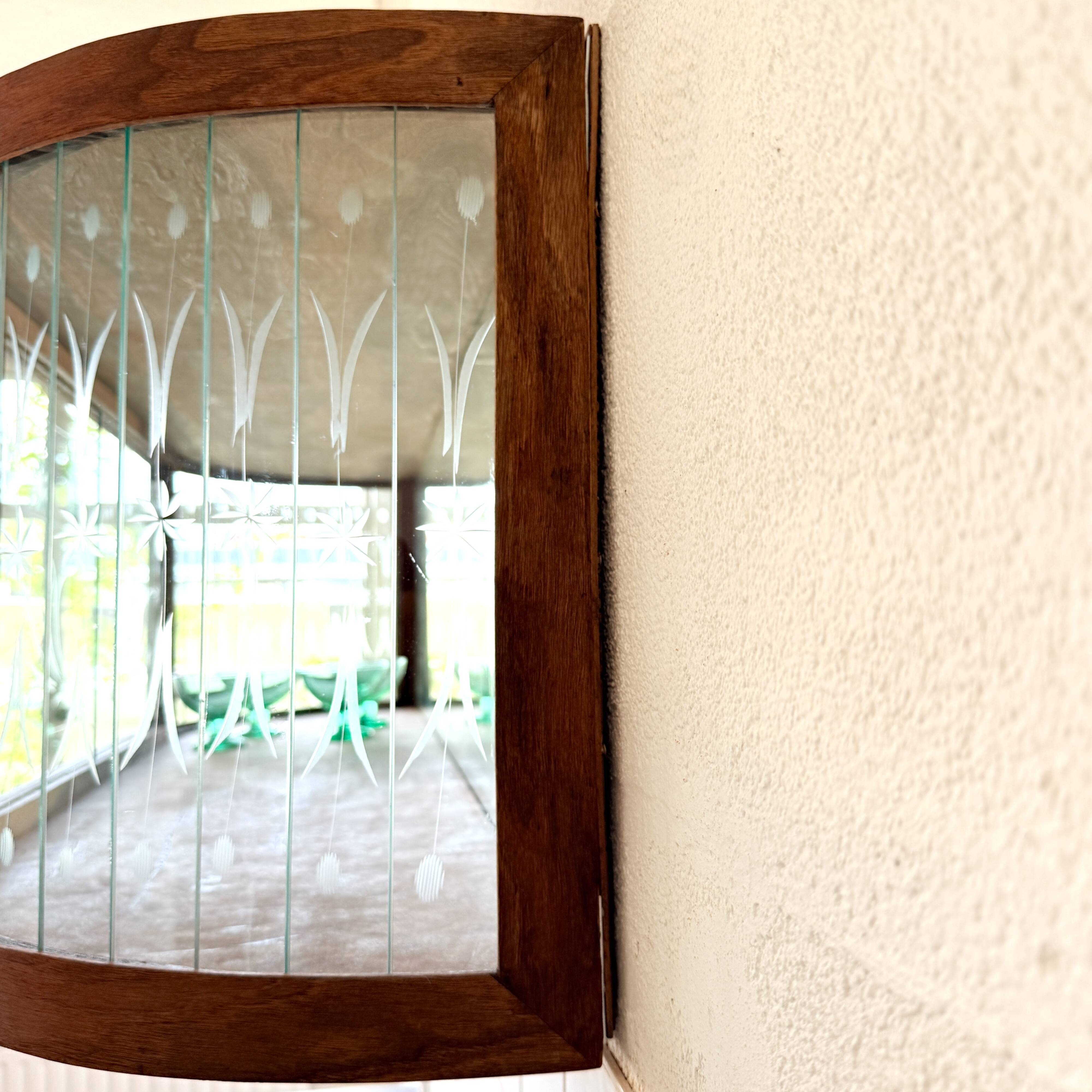 Art Deco-style wall-mounted display cabinet with floral engraving