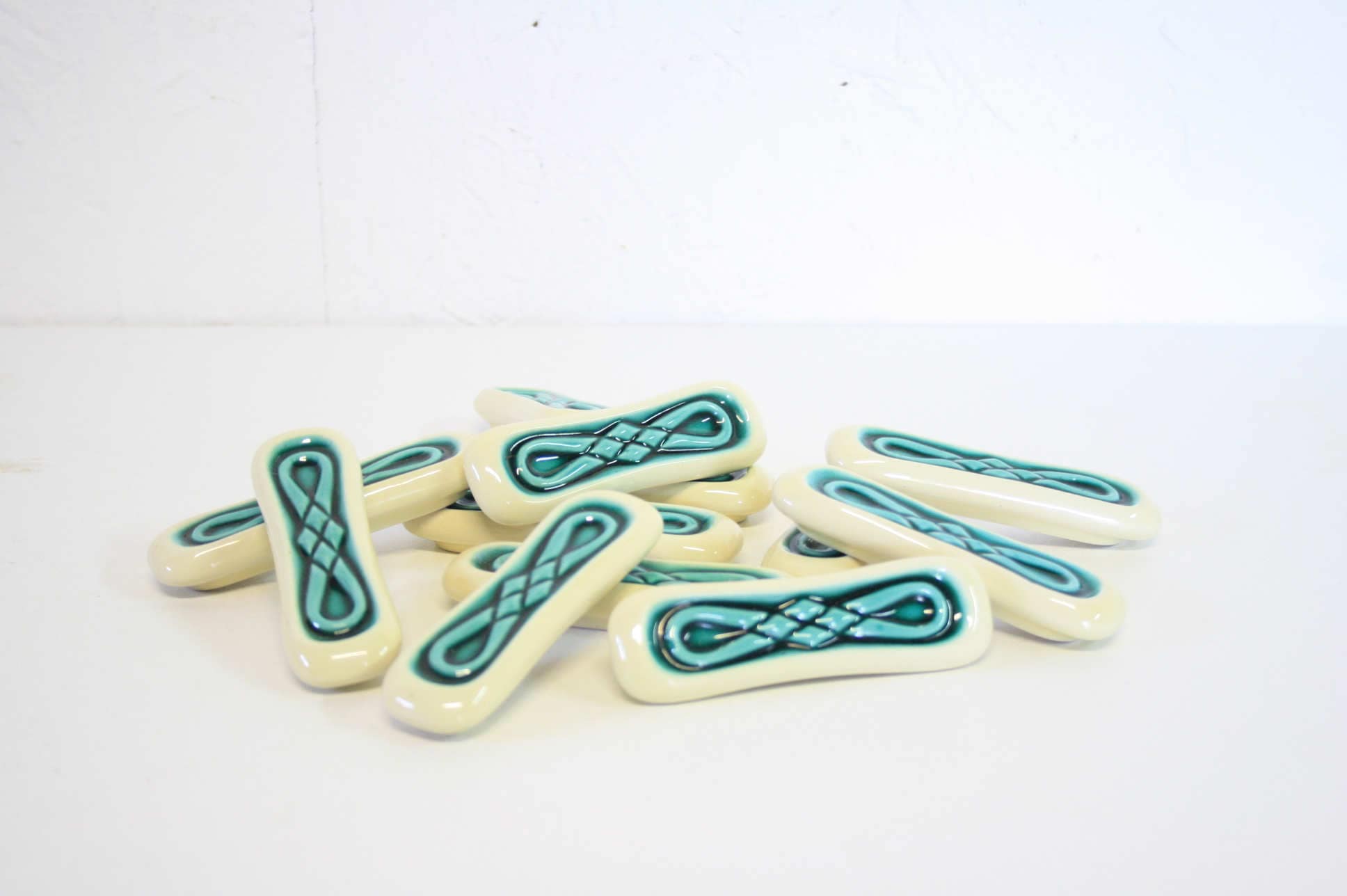 Set of twelve turquoise ceramic knife holders