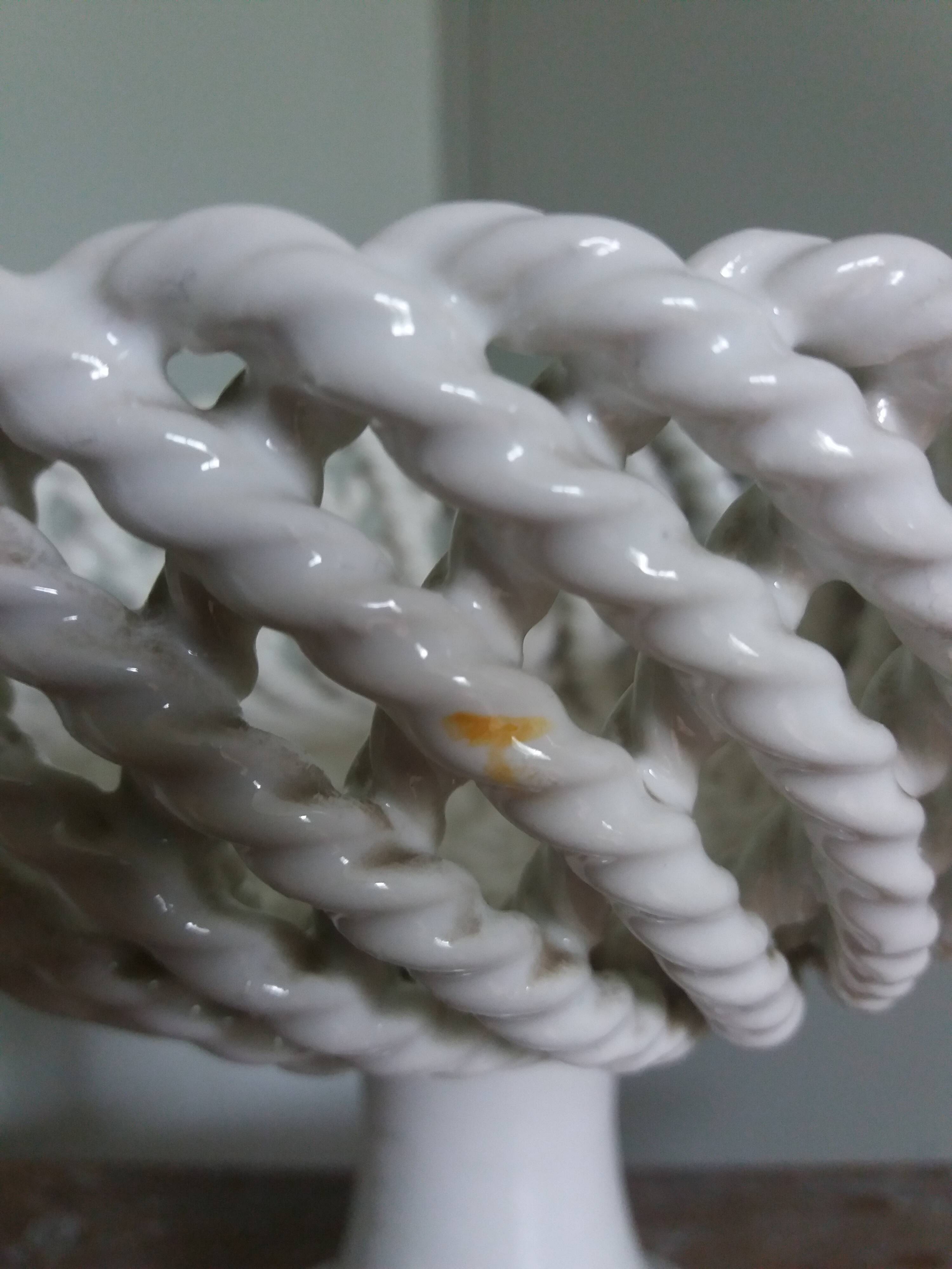 Cup on woven ceramic base with slip flowers