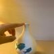 White ceramic with dolphin motif
