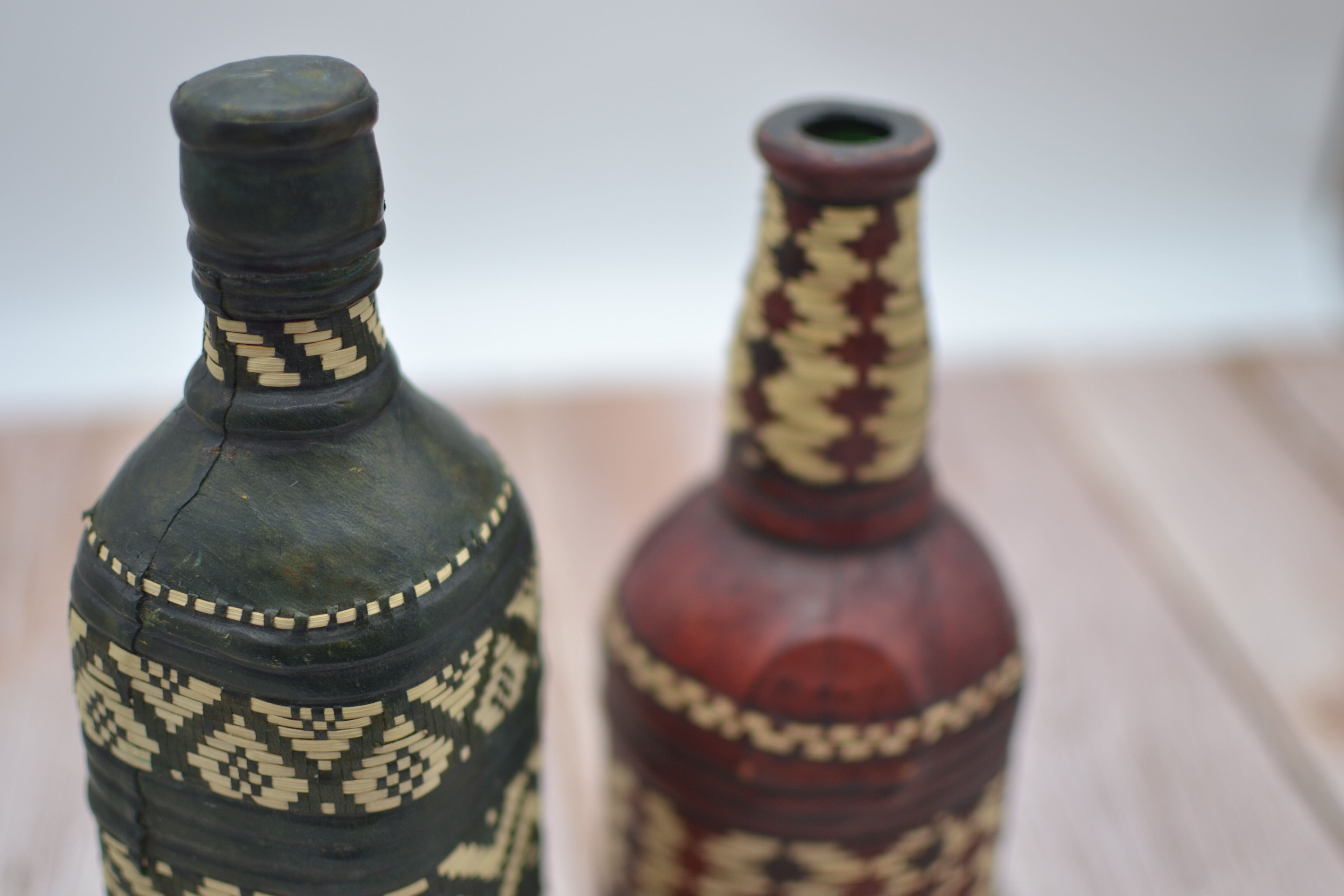Set of 2 decorative vintage bottles covered with leather & wicker