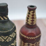Set of 2 decorative vintage bottles covered with leather & wicker