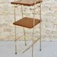 Pedestal table holders magazines in gilded metal and wood, 70s