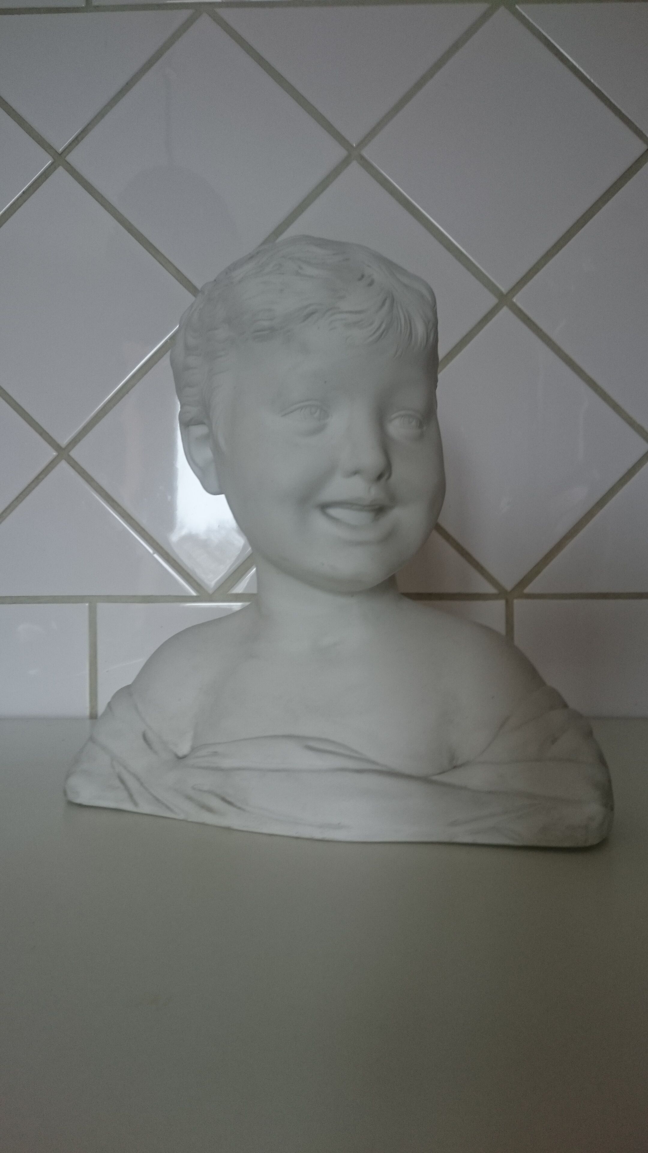 Laughing child bust after Donatello in Sèvres biscuit