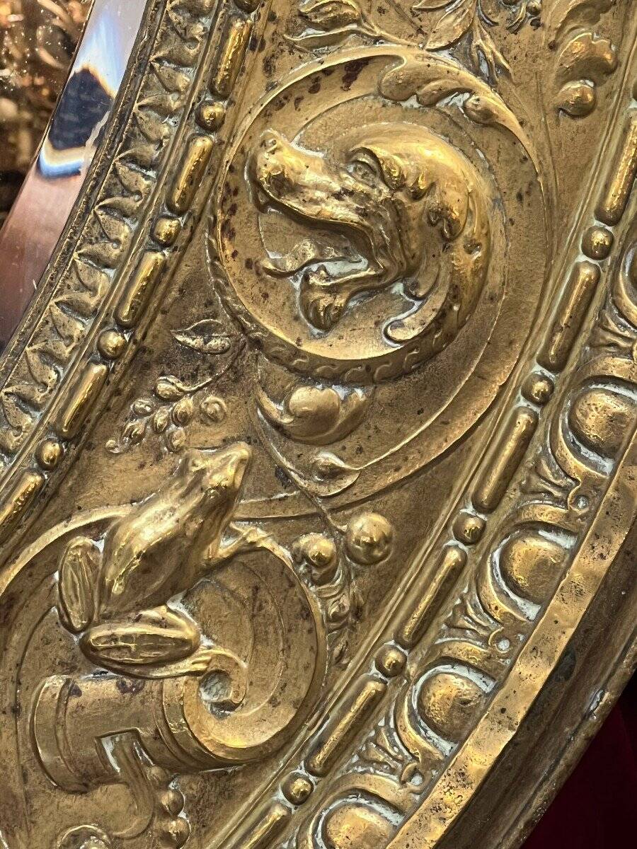 A. Arens, Antwerp, important oval mirror in repoussé brass with numerous animal decorations