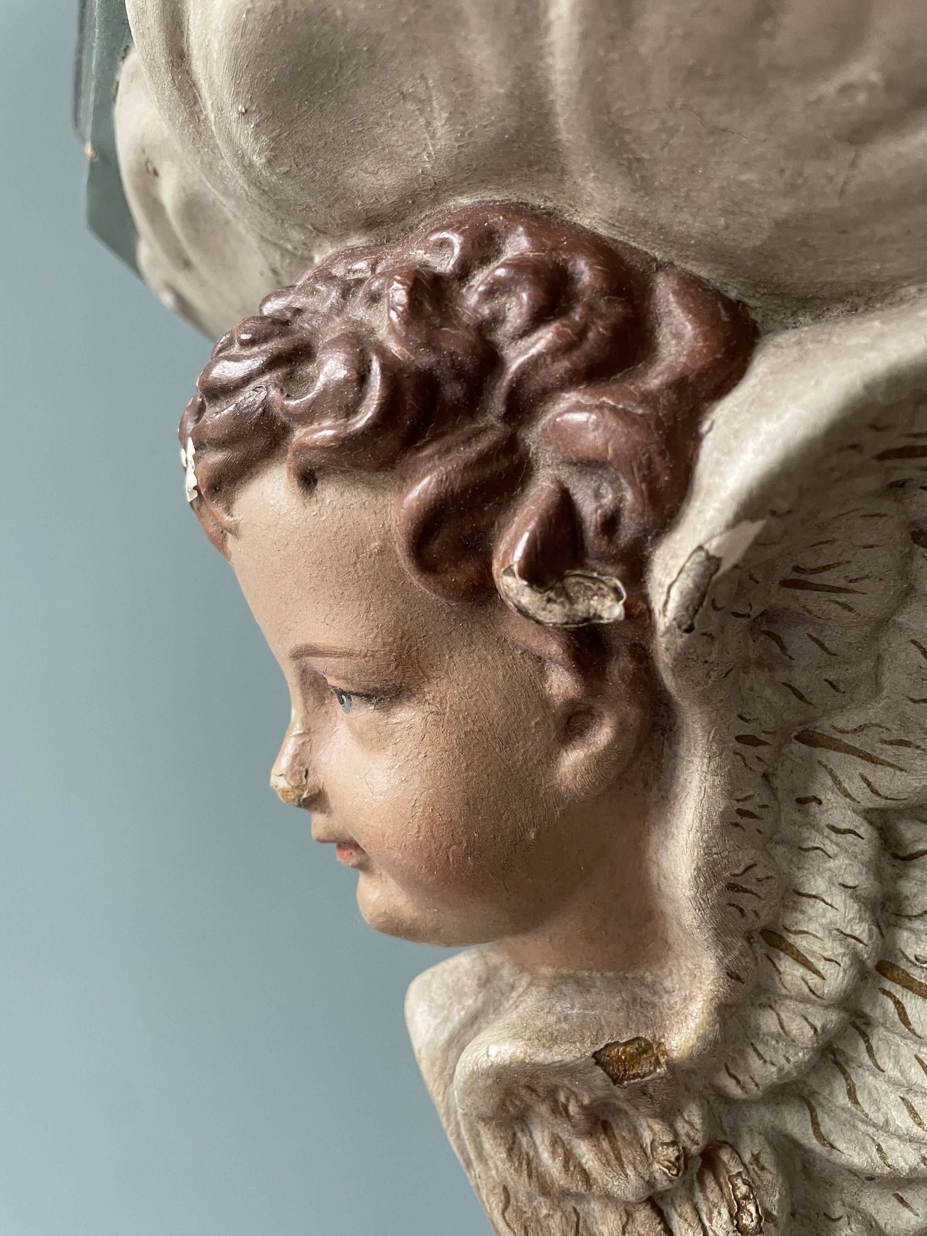 Nineteenth century plaster wall console, cherub decoration