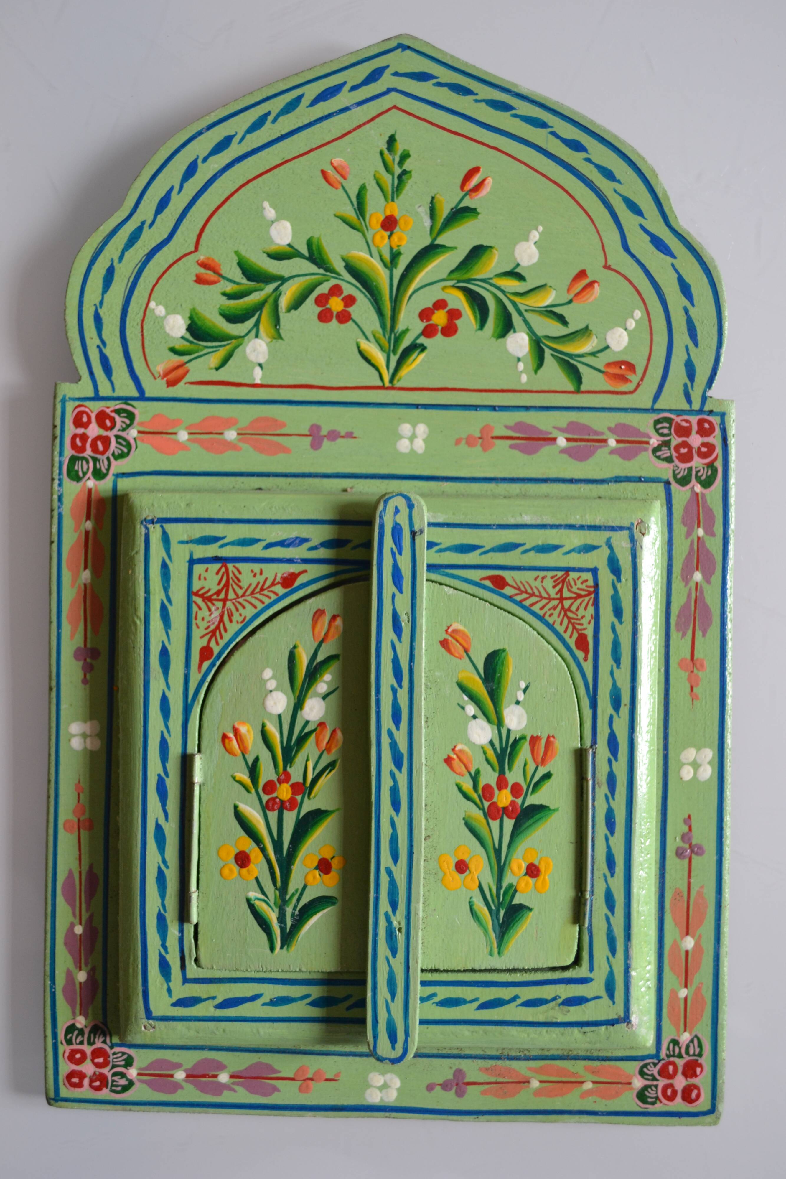 Mirror under shutters with painted flower decoration